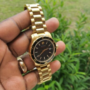 Movado Series 800 Black Dial Gold Steel Strap Watch For Men - 2600145